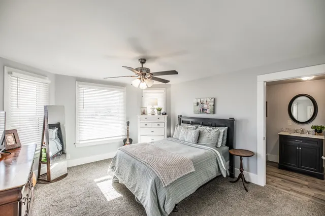 a bedroom with a large bed and a chandelier