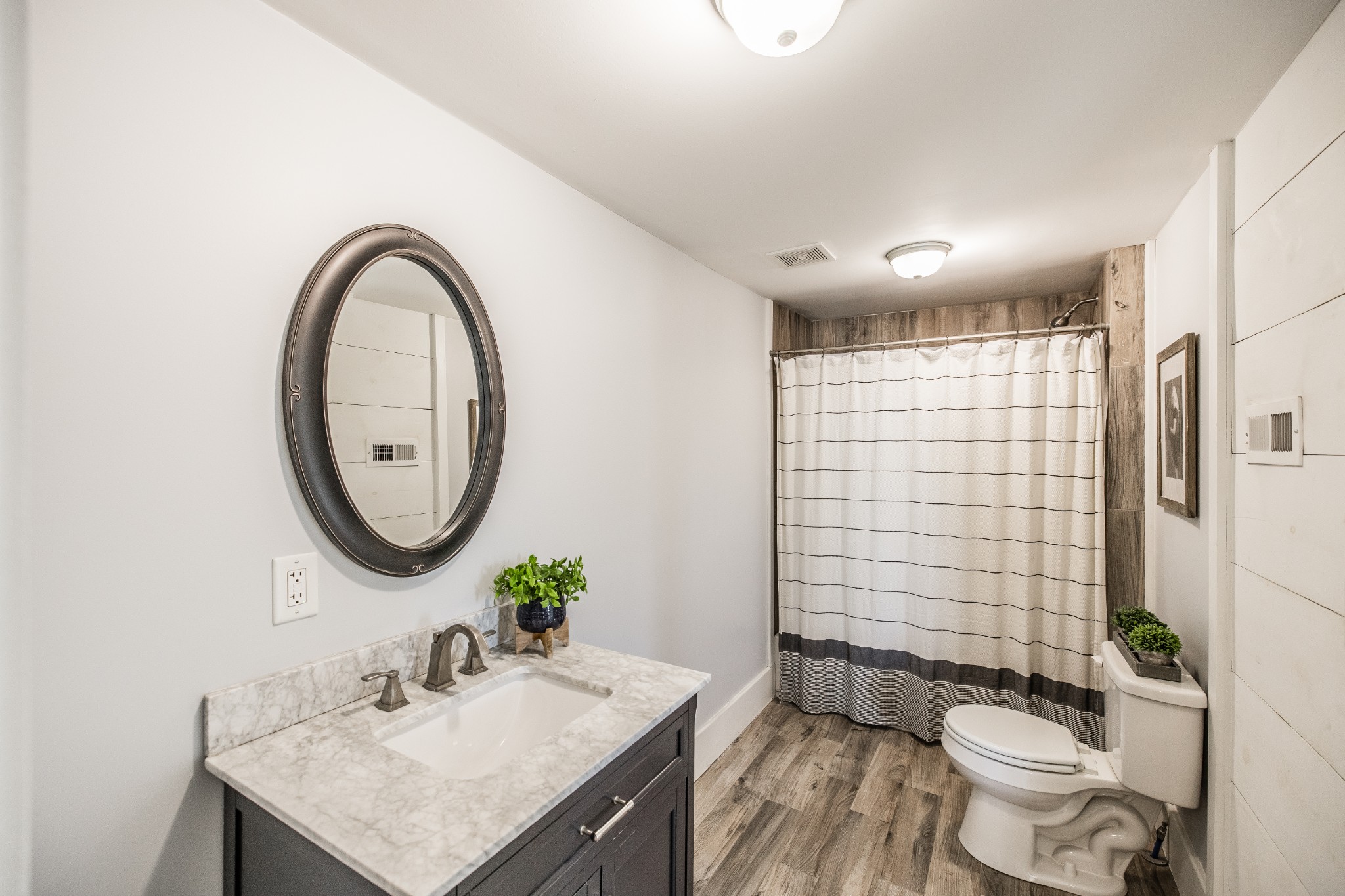 2999 Oak Grove Church Road Bethpage, TN 37022 - Photo 26 of 44 a bathroom with a sink a toilet and shower curtain