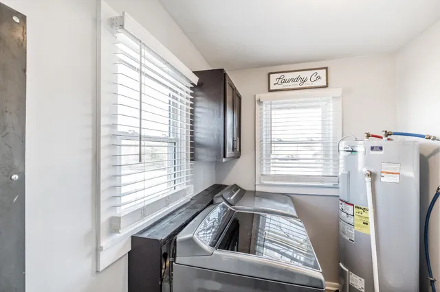 a kitchen with a window a refrigerator and washer