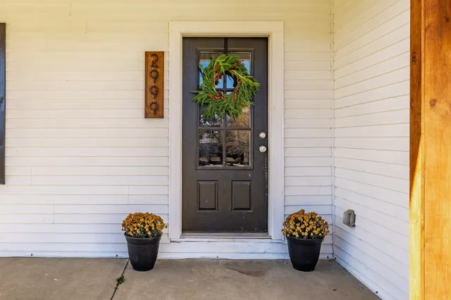 a front view of a house with outdoor seating