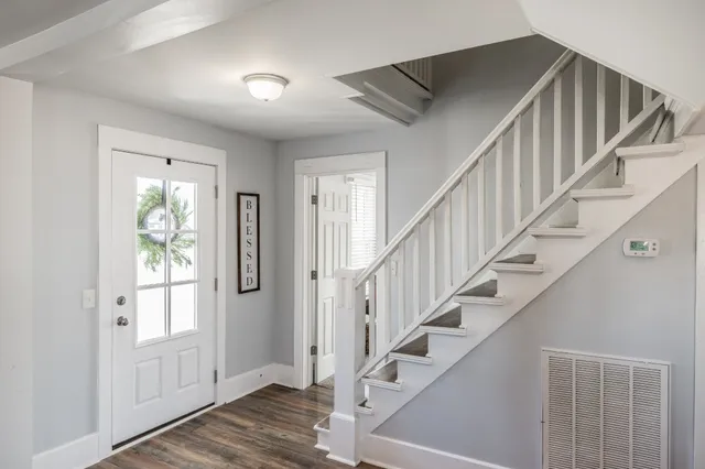 a view of entryway with wooden floor and stairs