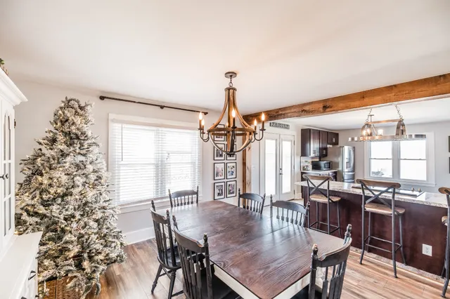a dining room with furniture window and wooden floor