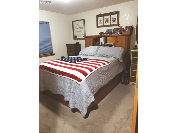 a bedroom with bed and a cabinets