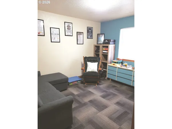 a living room with furniture and cabinets
