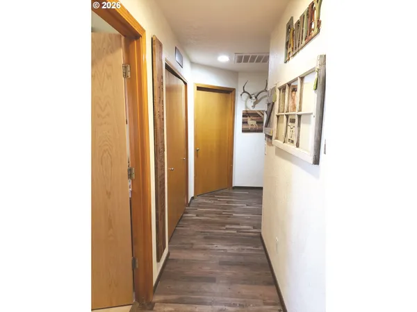 a view of a hallway with wooden floor