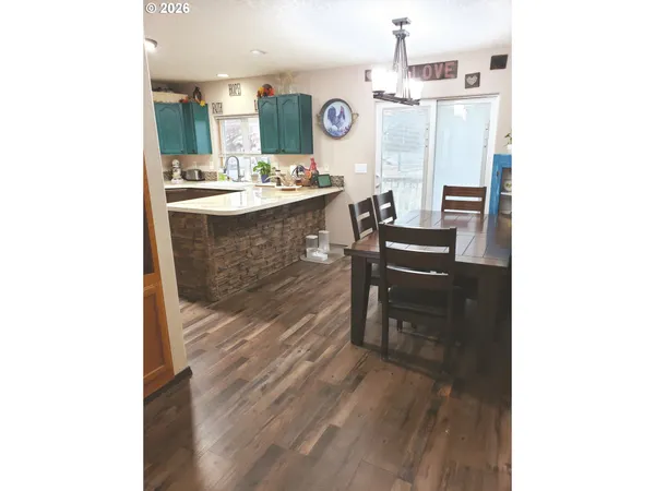 a hallway with a table and chairs