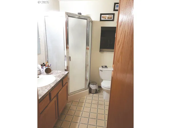 a spacious bathroom with a granite countertop sink toilet and shower