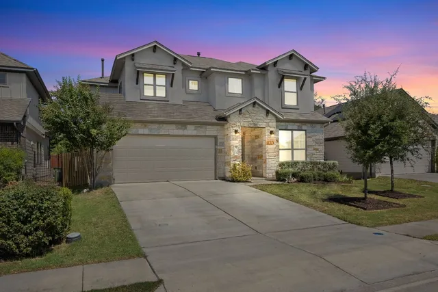 a front view of a house with a yard and garage