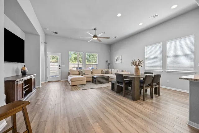 a living room with furniture a fireplace and a flat screen tv