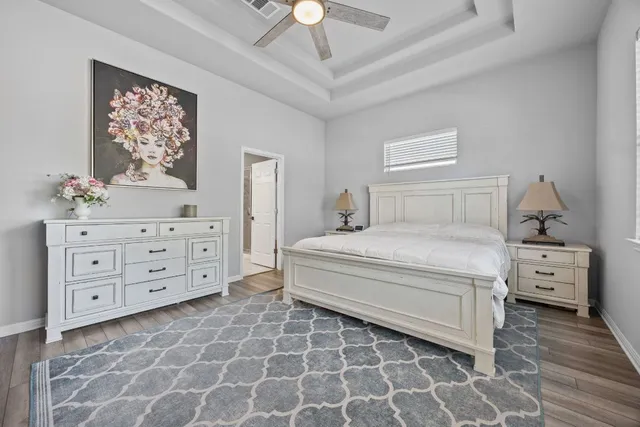 a bedroom with a bed and a chandelier