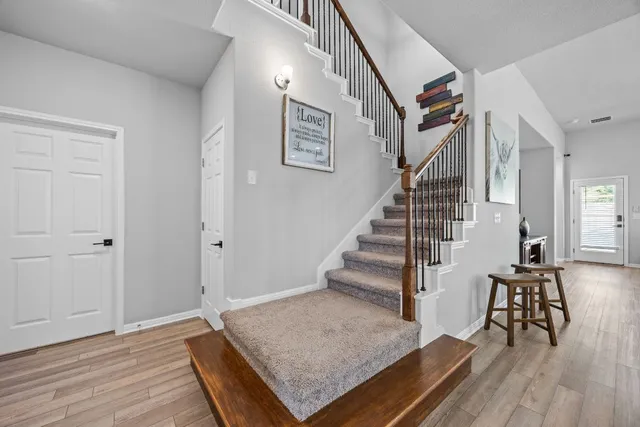 a view of entryway and hall with wooden floor
