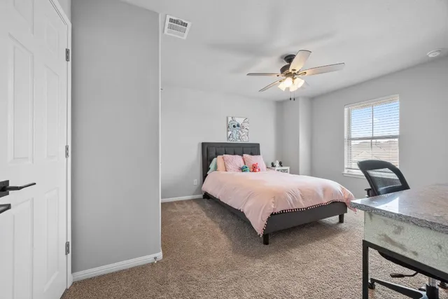 a bedroom with a bed dresser and a window