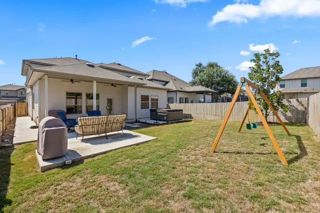 a view of a house with backyard porch and sitting area
