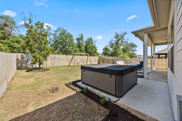 a view of a backyard with a large tree