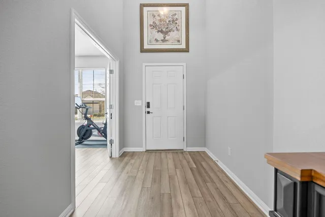 an empty room with wooden floor and a window