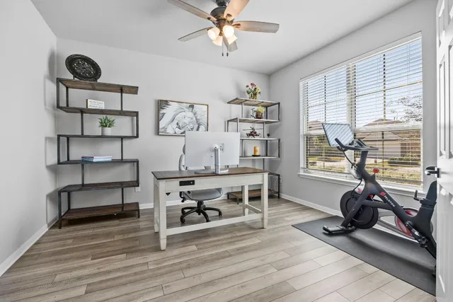 a view of a workspace with furniture and a window