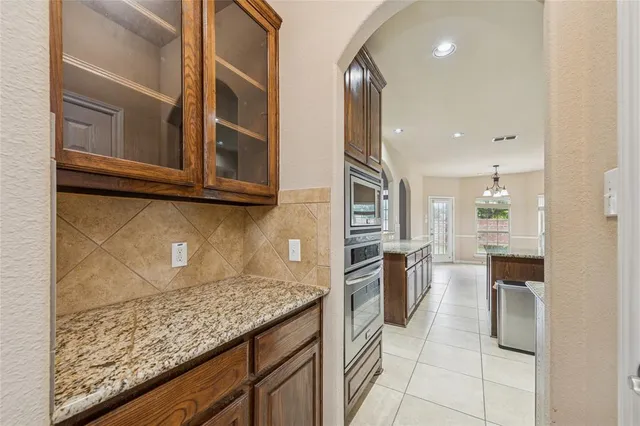 a kitchen with a refrigerator and microwave