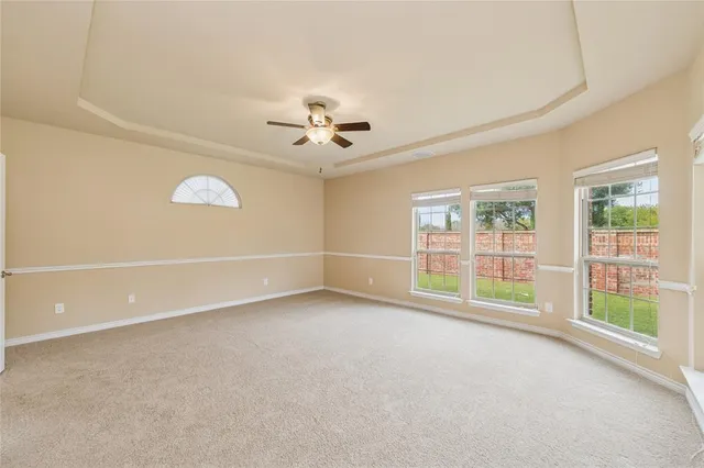 an empty room with a empty space and a ceiling fan