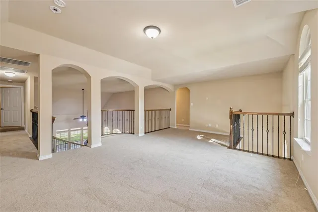 an empty room with fireplace and mirrors