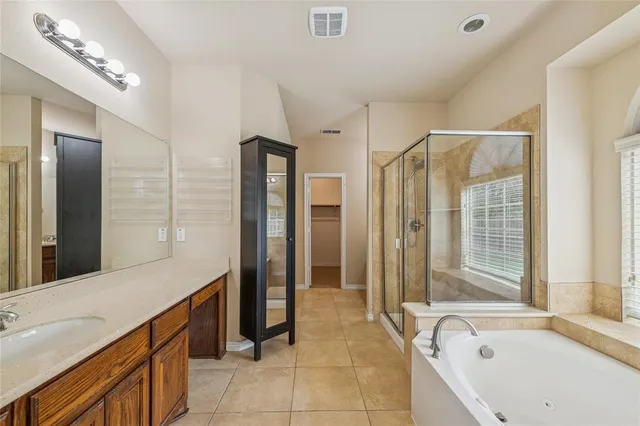 a spacious bathroom with a tub shower and sink