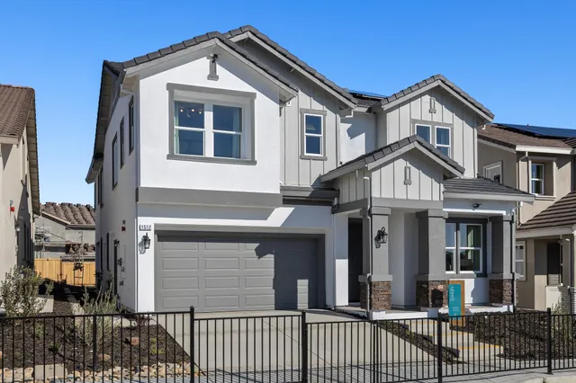 a view of a white house with large windows