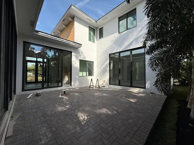 a view of a house with brick walls and a tree