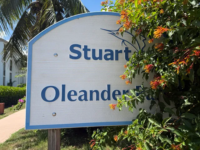 a view of sign board with potted plants