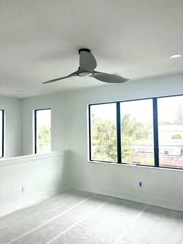 a view of a house with brick walls and a tree