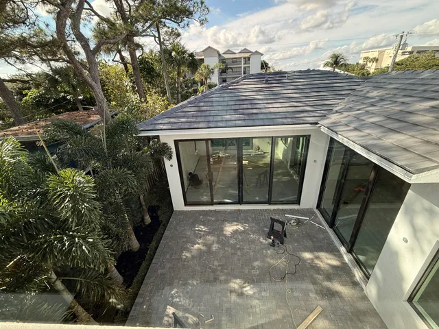 a view of a entryway door with potted plants