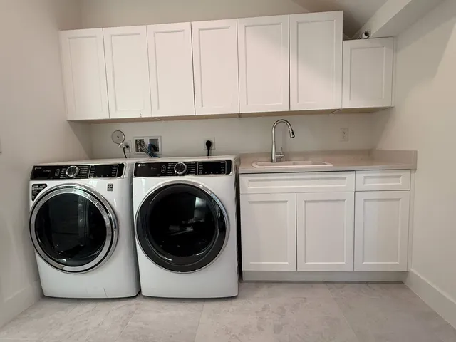 a view of sign board with potted plants
