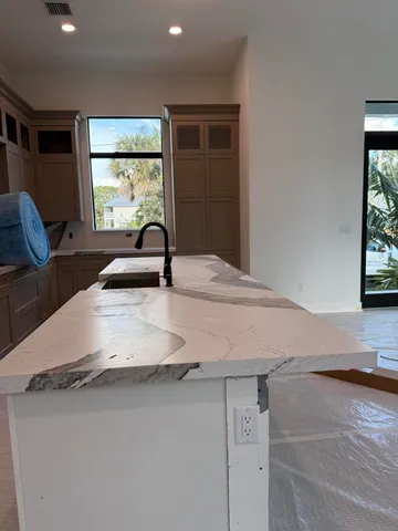a bathroom with a granite countertop sink a toilet and a large mirror