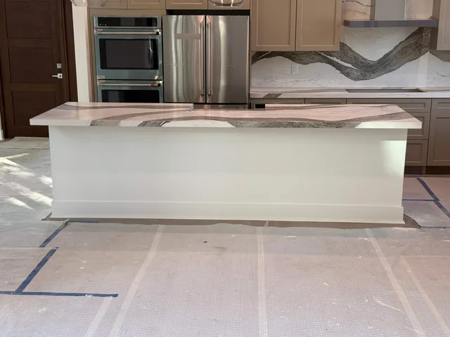 a bathroom with a granite countertop sink a toilet and a large mirror