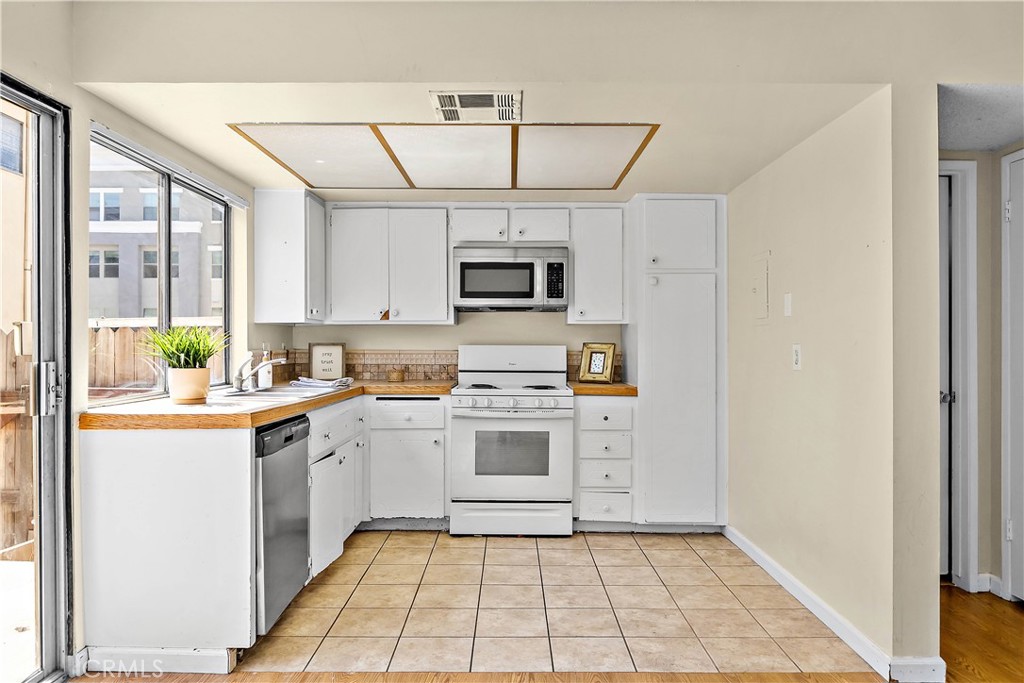 1386 3rd Street Duarte, CA 91010 - Photo 1 of 30 a kitchen with a stove top oven cabinets and a window