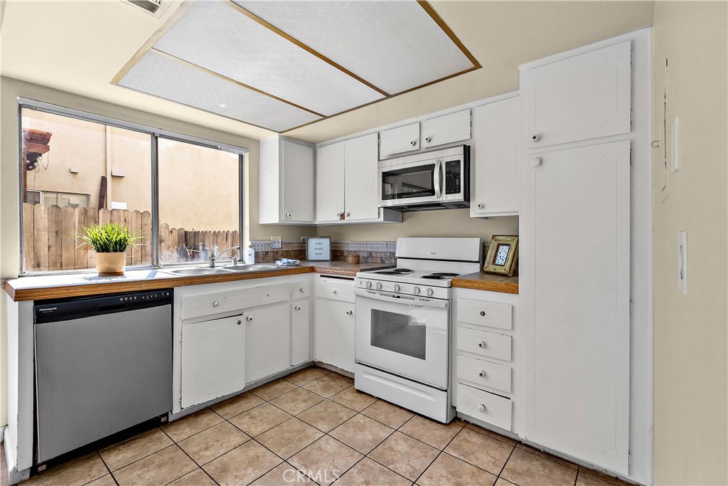 1386 3rd Street Duarte, CA 91010 - Photo 3 of 30 a kitchen with white cabinets appliances and a large window