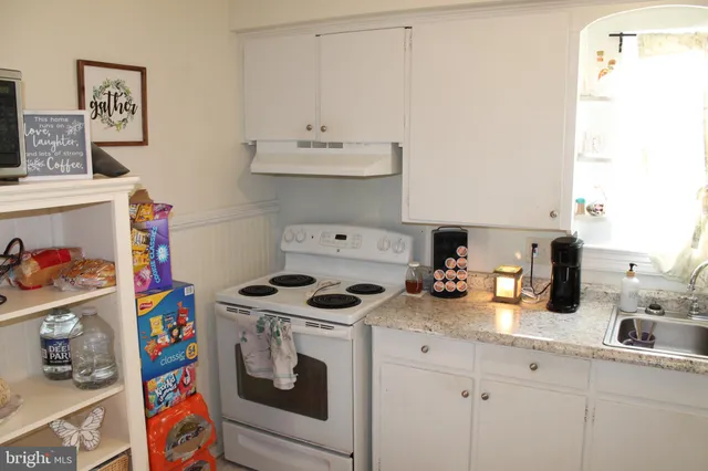 a kitchen with a stove and cabinets