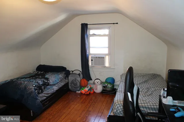 a bedroom with bed and a window