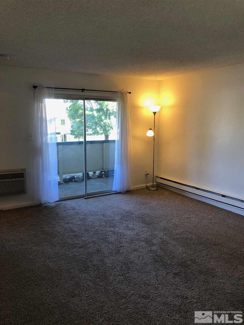 3942 Clear Acre Lane Reno, NV 89512 - Photo 13 of 24 a view of an empty room with a fireplace