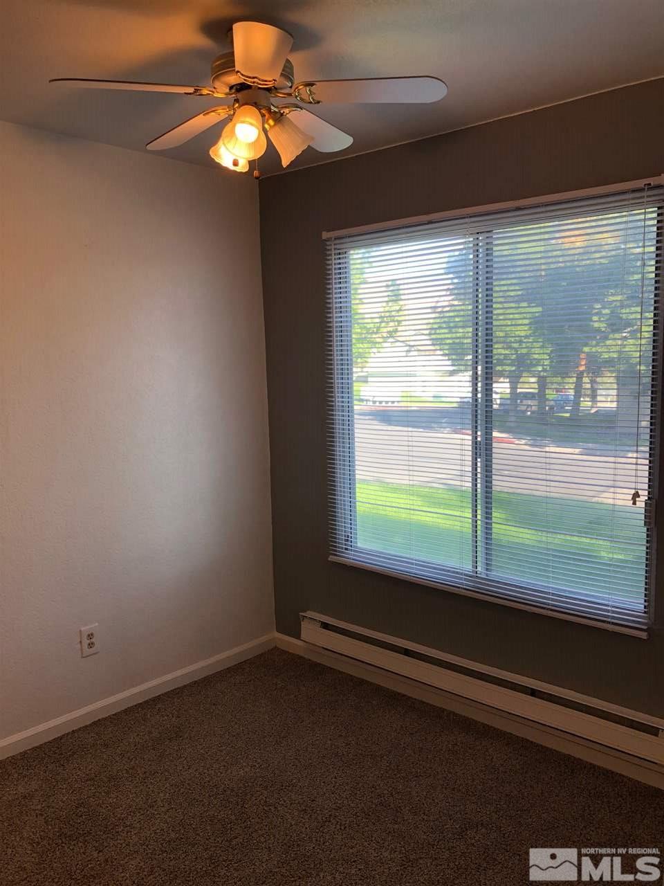 3942 Clear Acre Lane Reno, NV 89512 - Photo 14 of 24 a view of a livingroom with a large window bed and wooden floor