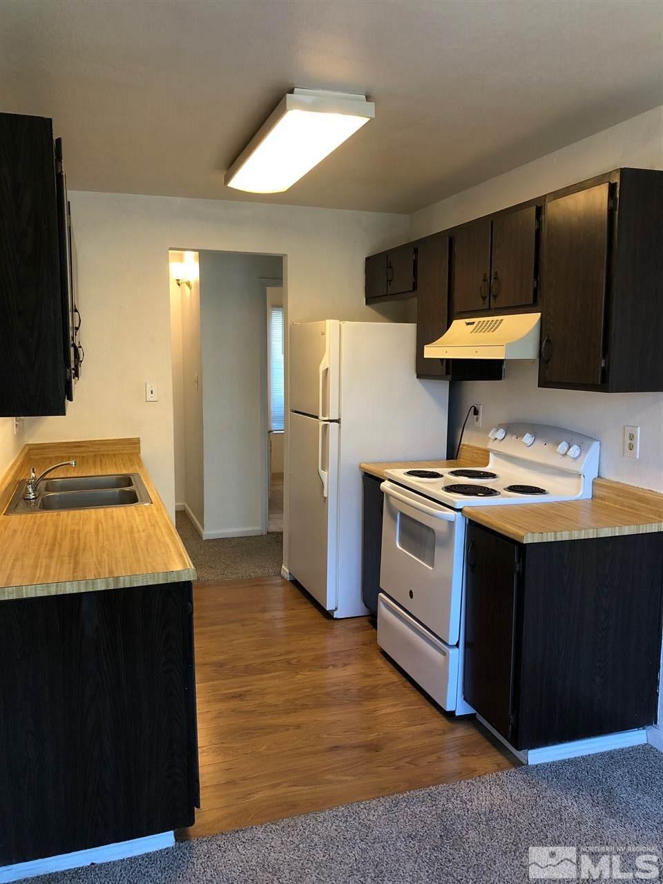 3942 Clear Acre Lane Reno, NV 89512 - Photo 5 of 24 a kitchen with stainless steel appliances granite countertop a sink stove and refrigerator