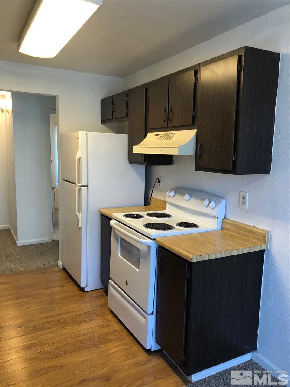 3942 Clear Acre Lane Reno, NV 89512 - Photo 7 of 24 a kitchen with a sink a stove and a refrigerator