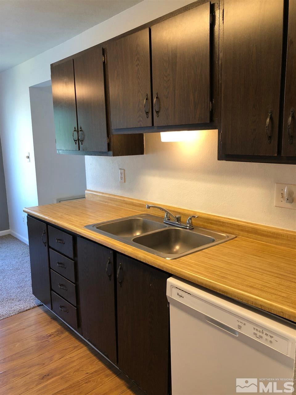 3942 Clear Acre Lane Reno, NV 89512 - Photo 9 of 24 a kitchen with wooden cabinets and a sink