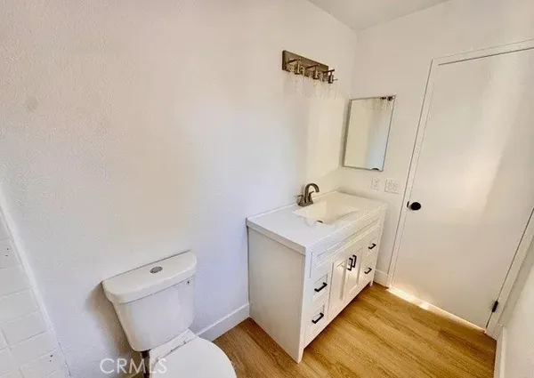 a bathroom with a sink and mirror with toilet