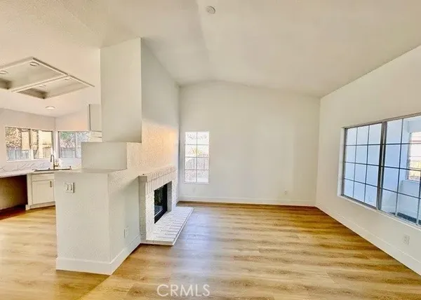 a view of kitchen with stainless steel appliances granite countertop cabinets and wooden floor