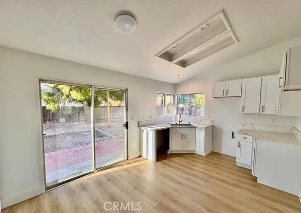 a large kitchen with a wooden floor and cabinets