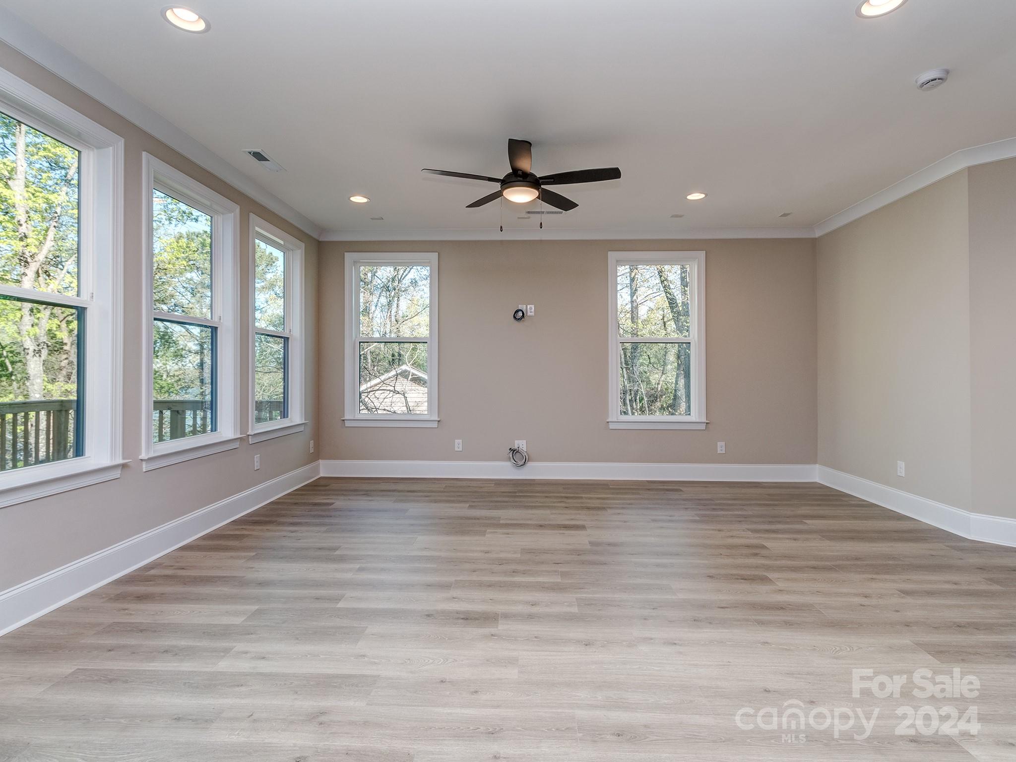 9017 Palau Court Tega Cay, SC 29708 - Photo 10 of 47 a view of an empty room with a window and wooden floor