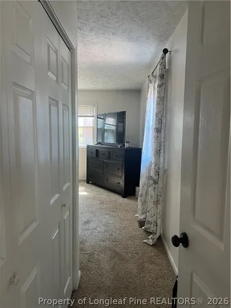 a bedroom with a bed a window and dresser