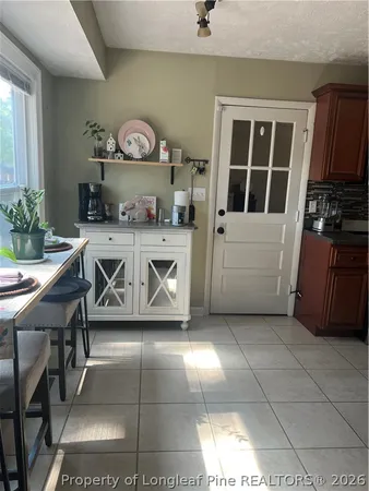 a kitchen with stainless steel appliances wooden cabinets a stove top oven a sink and dishwasher
