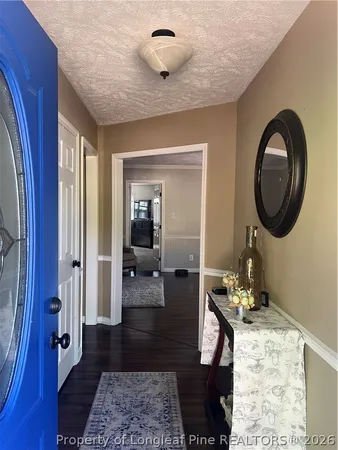 wooden floor in living room with a window