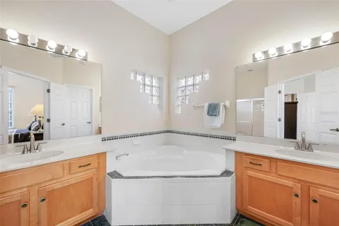 a bathroom with a granite countertop sink a toilet and bathtub