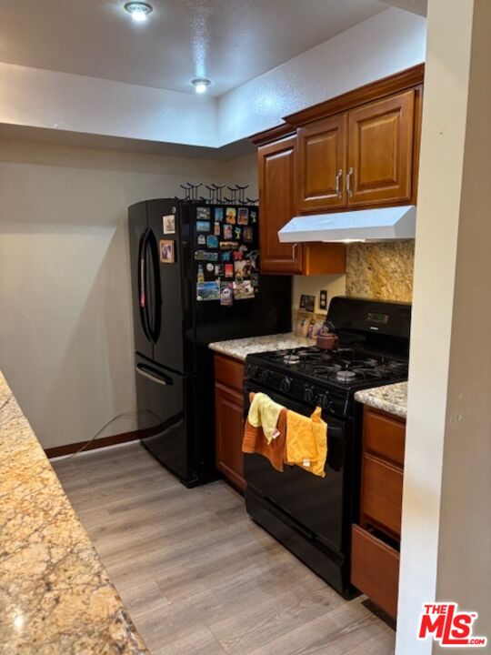 1119 Albany Street, Unit 241 Los Angeles, CA 90015 - Photo 12 of 21 a kitchen with stainless steel appliances granite countertop a stove and a refrigerator